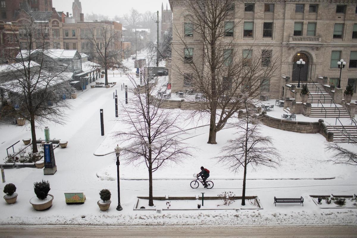 A bicyclist rides down the sidewalk along Main Street past the Old Fayette County Courthouse in Lexington, Ky., Monday, February 15, 2020. Lexington is currently under a ice storm warning according to the National Weather Service.