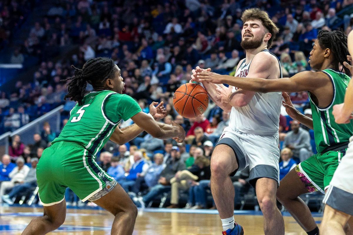 Great Crossing’s Junius Burrell (5) strips the ball from Magoffin County’s Aden Barnett (2) during Friday’s quarterfinal matchup in Rupp Arena. The Warhawks forced 15 Magoffin turnovers and committed only nine.