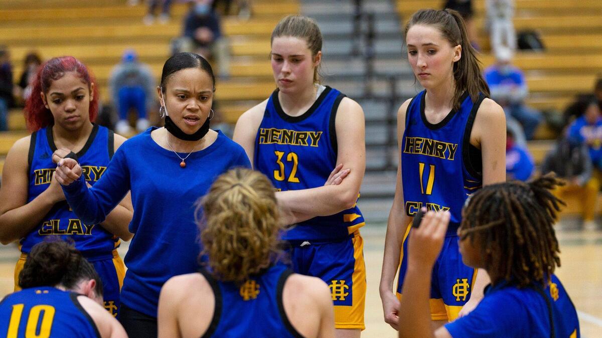 Henry Clay head coach Ashley Garrard huddles with her team during Thursday night’s game at Frederick Douglass. The Blue Devils are off to a 6-6 start in Garrard’s first season.