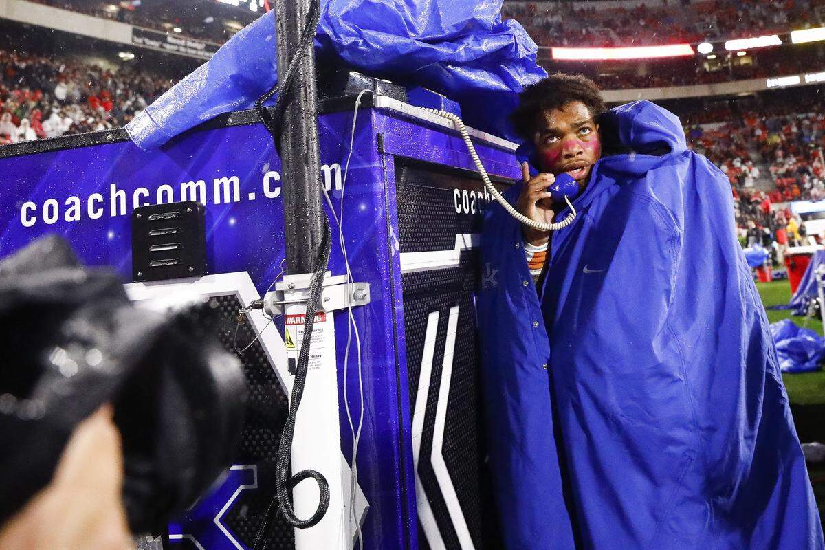 Lynn Bowden took a call from the coaches during last Saturday’s rain-soaked loss at Georgia. More heavy rain is in the forecast for this week’s game against Missouri in Lexington.