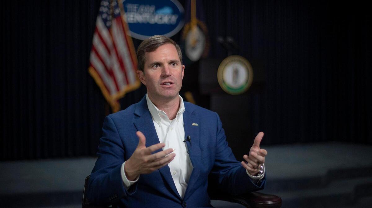 Kentucky Gov. Andy Beshear speaks to a reporter at the state Capitol in Frankfort on Wednesday, Dec. 7, 2022.