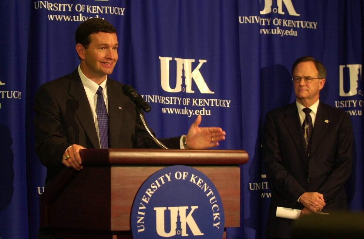 Mitch Barnhart spoke on July 15, 2002, after having been introduced as Kentucky athletics director. Looking on was then-UK president Lee T. Todd Jr.