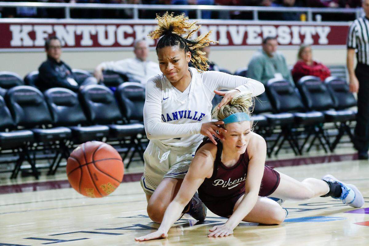 Danville’s Love Mays (1) dives on the ground against Pikeville’s Kylie Grace Hall (3) after a loose ball during the All “A” Classic girls tournament quarterfinals game at EKU McBrayer Arena in Richmond, Ky., Friday, January 27, 2023. The small school tournament started in 1980.