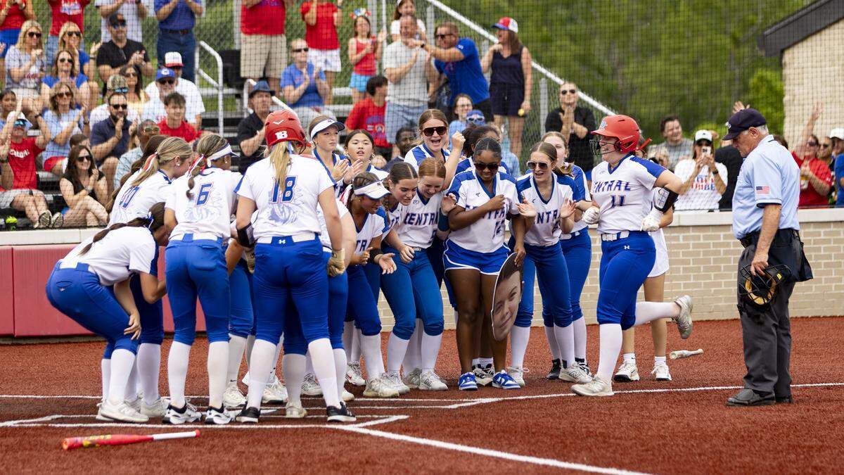 Madison Central’s dugout emptied to celebrate a leadoff home run by Luciana Robinson (11) in the second inning of the 11th Region Softball Tournament championship game at George Rogers Clark High School in Winchester on Saturday.