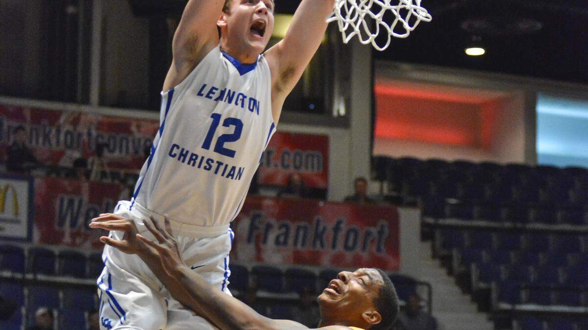 Lexington Christian's Matt Rose dunked on an alley-oop pass over Shawnee's Joseph Jewell during the opening round of the boys Touchstone Energy All-A Classic on Jan. 29 in Frankfort.