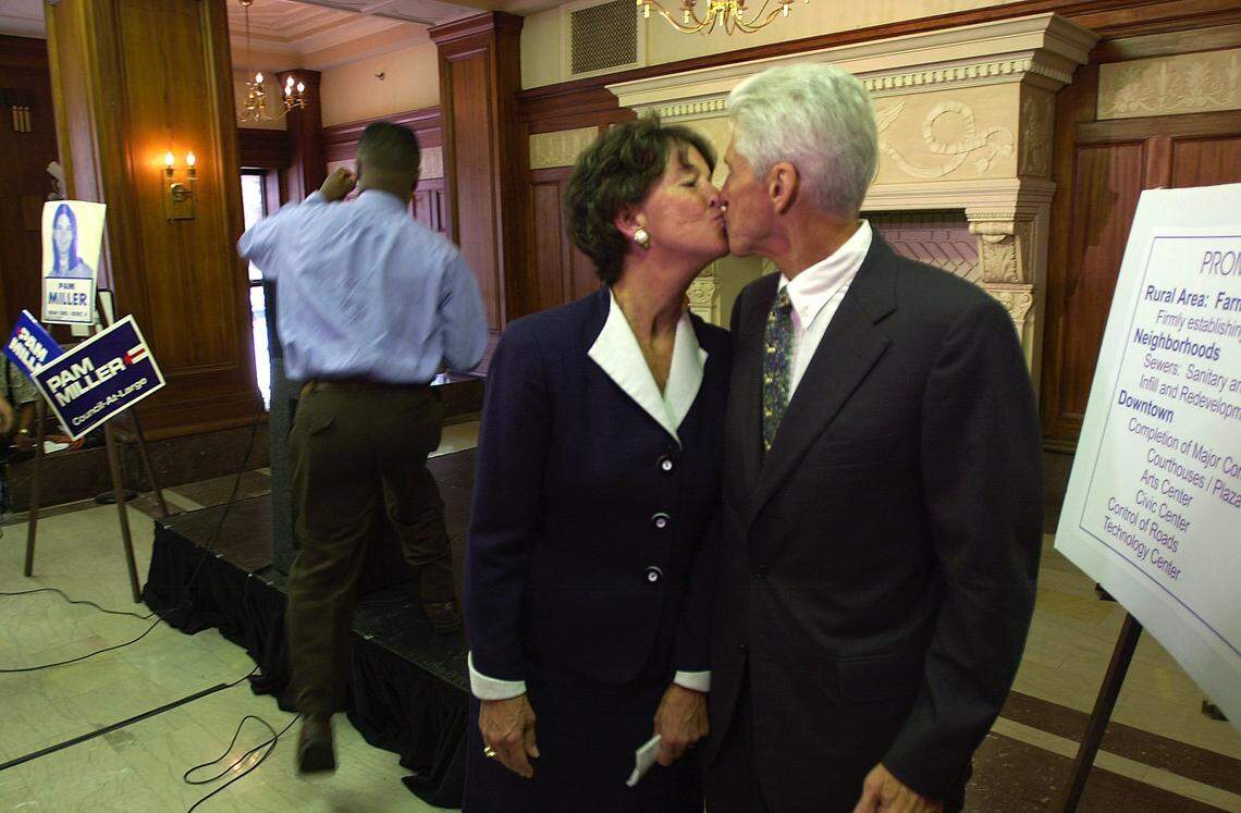 Lexington Mayor Pam Miller gives a kiss to her husband Ralph Miller, after she announced she would not run for Mayor next term at the Lexington Urban county government building on monday May 7, 2001 in Lexington, Ky.