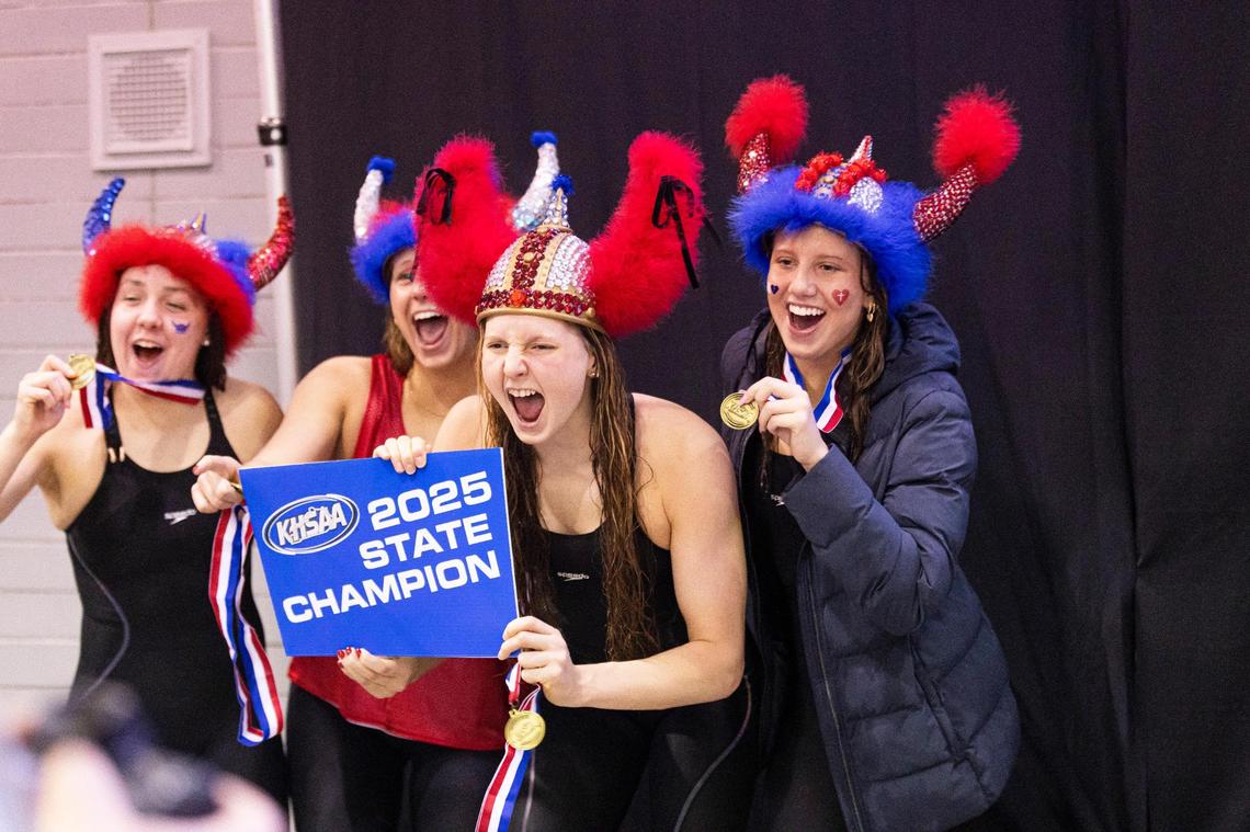The Sacred Heart 400-yard freestyle relay team, including junior anchor Charlotte Crush, center, along with Ava Grazziani, Eli Summa and Sydney Green, celebrates after winning the event during the 2025 KHSAA State Swimming and Diving Championships at the University of Kentucky’s Lancaster Aquatic Center on Friday.