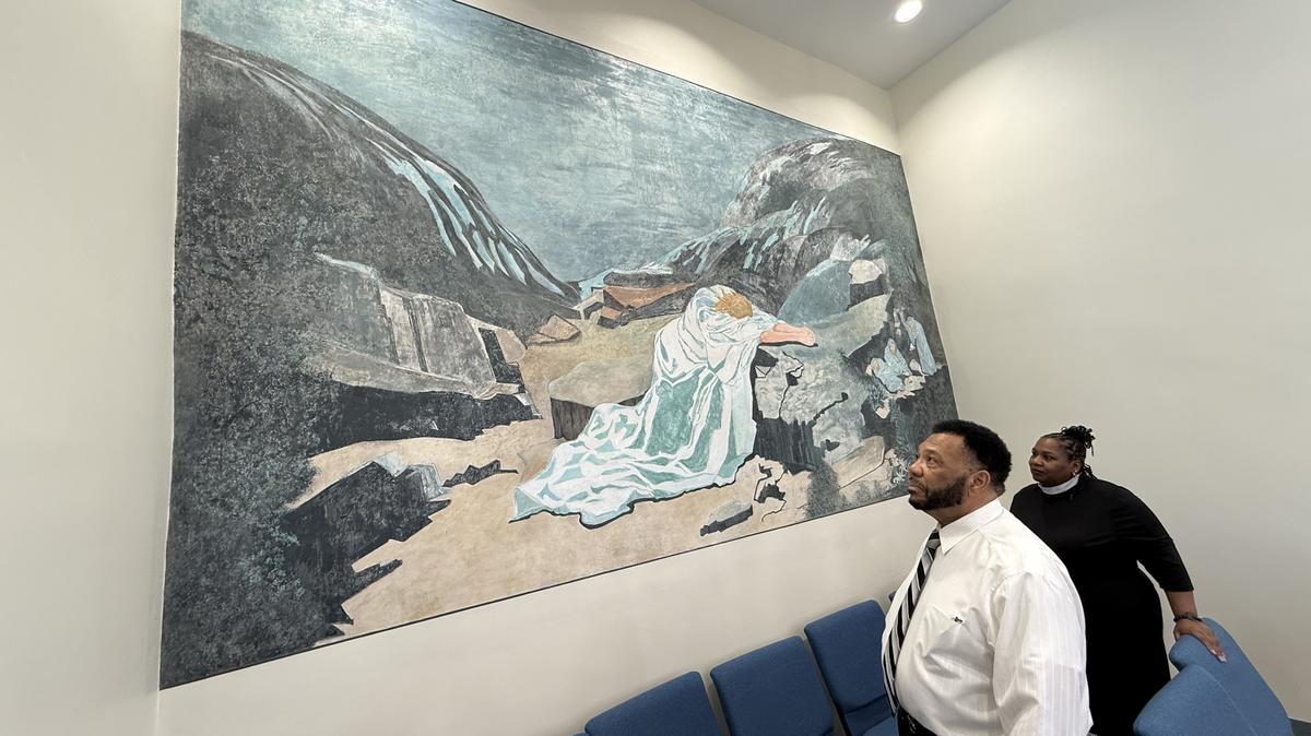 Thomas Bright, 70, a steward and trustee at St. James African Methodist Episcopal, the oldest historically Black church in the Graves County seat and Rev. Gloria Lasco look at the mural by renowned painter Helen LaFrance. The church was damaged by the 2021 tornado that destroyed much of Mayfield, but recently reopened.
