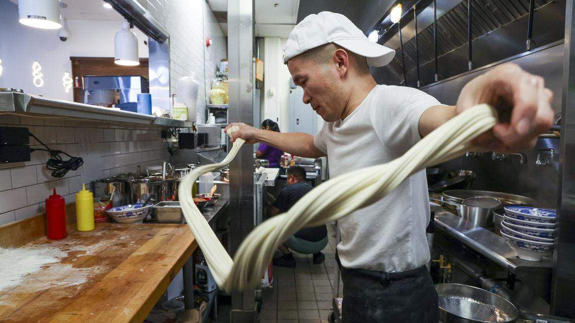 Jack Lin pulls and stretches dough for noodles Wednesday, Aug. 13, 2025, at Kung Fu Noodle, a new Chinese restaurant located on the ground floor of the CenterCourt complex at 535 S. Upper St., a block from the University of Kentucky campus. Owner Dennis Zhang said having fresh made noodles vs. machine made ones bring a “soft” and “unique texture” to its entrees, particularly its most famous dish, Lanzhou beef-noodle soup that his homeland is known for.