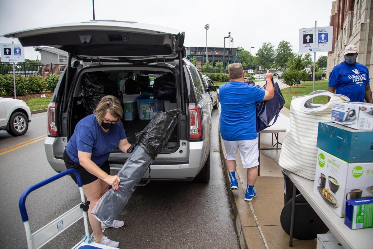 Brad and Beth Turner help unload their son’s belongings from their car to move him into his residence hall Monday on the UK campus in Lexington.