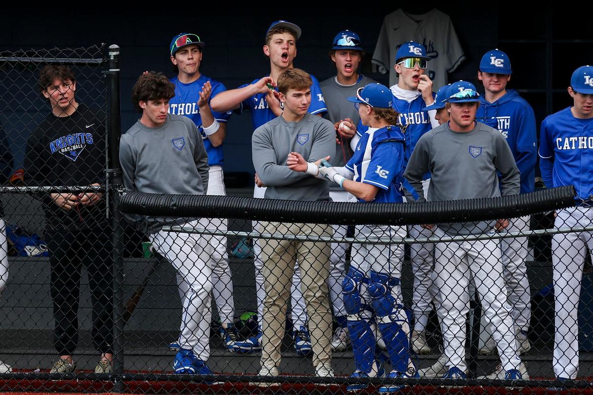 Lexington Catholic’s Owen Jenkins, center, talked with catcher Brady Wasik in the dugout during the Knights’ game against Manual at Lexington Catholic High School on Friday. Jenkins is out due to a minor injury.