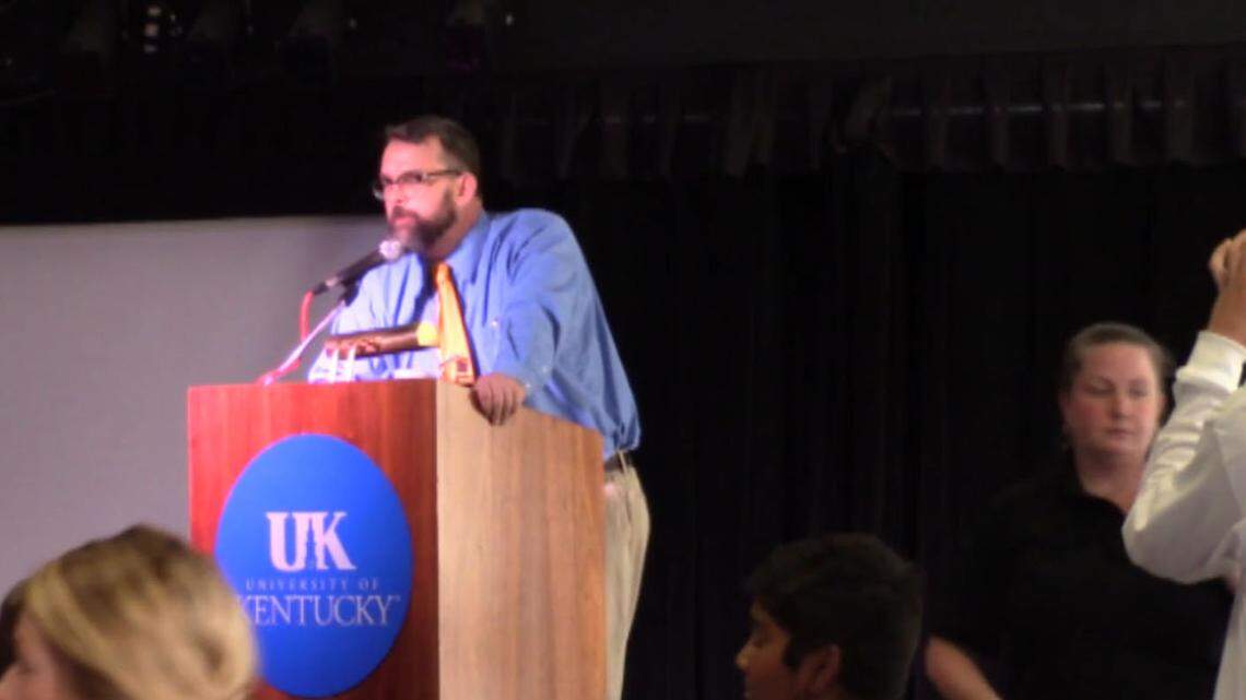 DuPont Manual High School journalism teacher James Miller, who brought students to a Constitution Day event Wednesday at the University of Kentucky, denounced racist remarks made at the event by U.S. Senate write-in candidate Robert Ransdell. "I apologize that you were subjected to that at an official school event," he told students.
