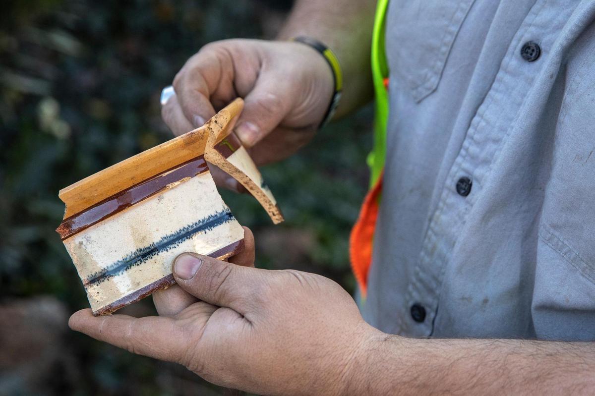 Jason Flay, an archaeologist at Acheulean Consulting, held a soup dish discovered under Triangle Park in Lexington.