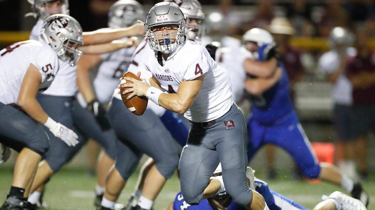 Pulaski County’s Drew Polston (4) runs the ball past Lexington Catholic defenders during the Traditional Bank Bluegrass Bowl at Lexington Catholic High School in Lexington, Ky., Friday, Aug. 27, 2021.