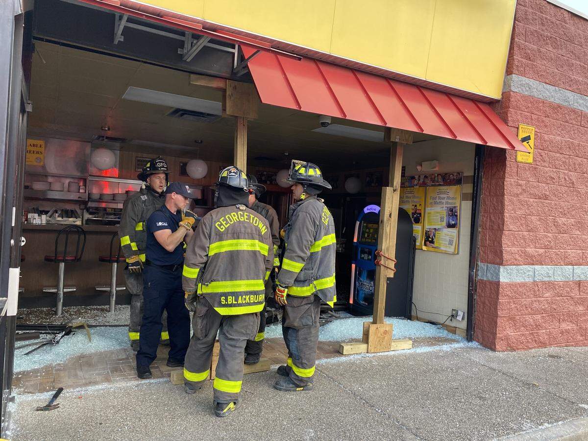 Firefighters at the scene of an accident in which a truck hit a Waffle House in Georgetown, Ky.