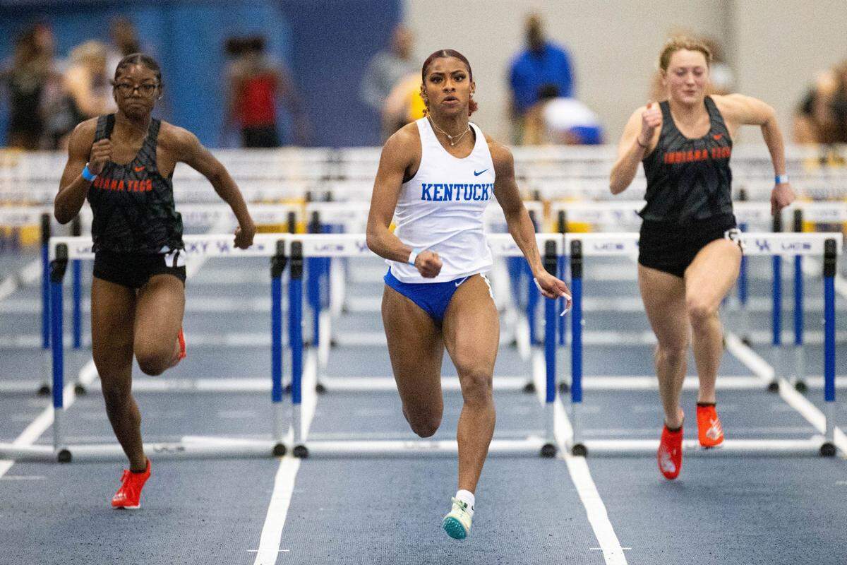 Kentucky’s Masai Russell, center, runs in the 60-meter hurdles race during the Rod McCravy Memorial indoor track and field meet in Lexington last month. Russell is not only one of the nation’s fastest women, she has the largest social media following of any UK athlete.