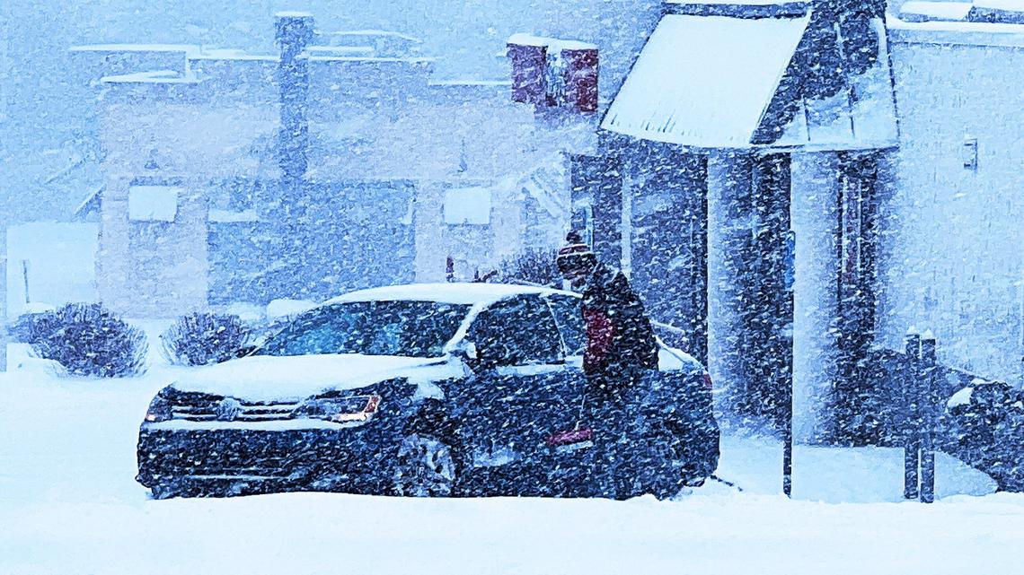 A man attempts to dig his vehicle out of the snow on New Circle Rd on January 5, 2025, in Lexington Ky.