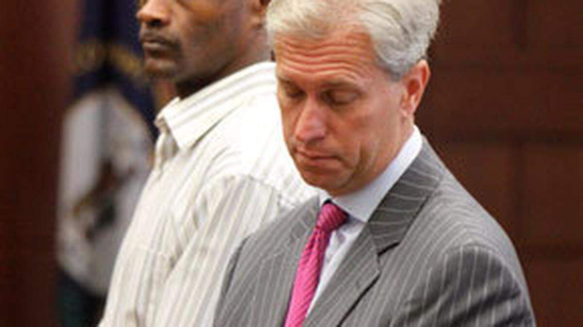 Former University of Kentucky basketball star Ed Davender, left, with attorney Steve Romines, was sentenced Friday afternoon in Fayette Circuit Court to eight years in prison for running a UK basketball ticket scam totaling more than $70,000.