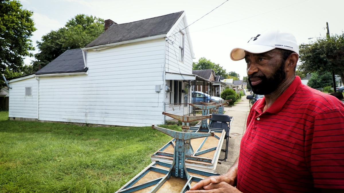 Rev. Mike Wilson stands in front of his father’s home on Dakota Street on August 8, 2019. Wilson and others on the East End homeowners are under increasing pressure from investors to buy their homes and land.