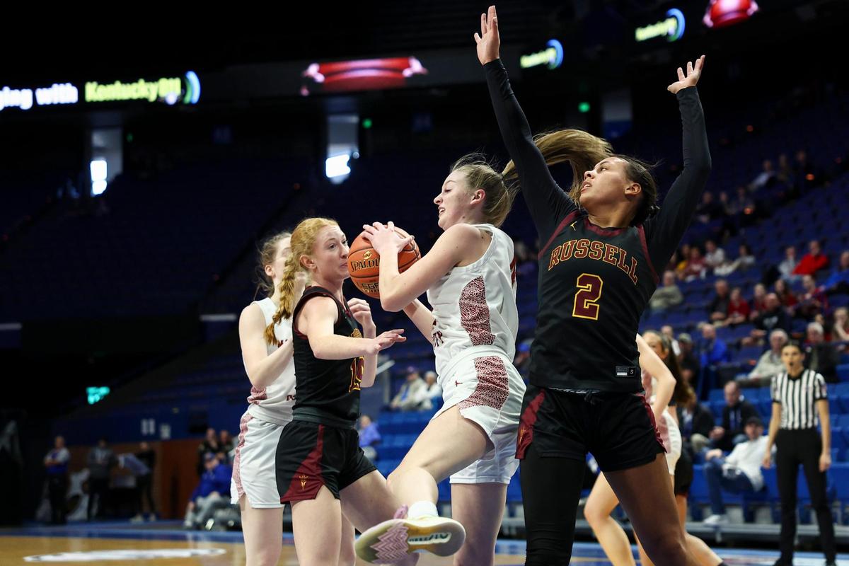 McCracken County’s Claire Johnson (4) grabs a rebound against Russell’s Shaelyn Steele (2) and Courtney Fitzpatrick during their first-round game in Rupp Arena on Wednesday.