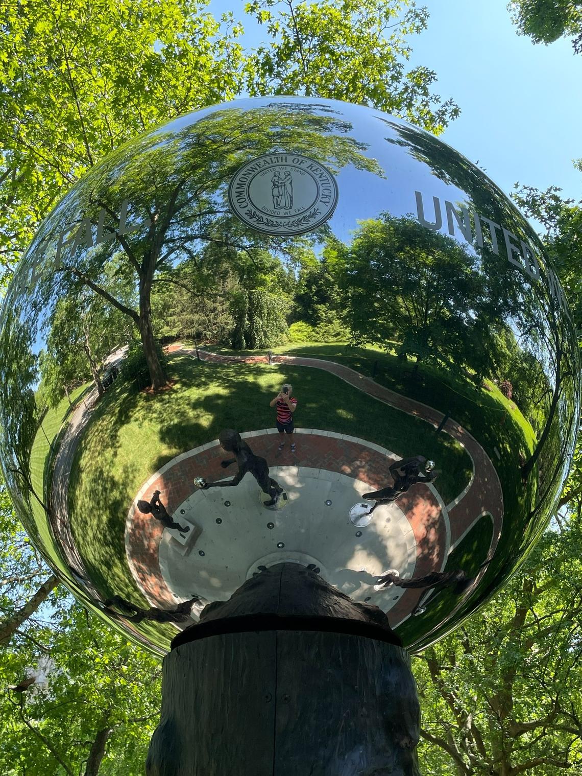 The glass globe atop the Kentucky COVID memorial in Frankfort carries the state motto and the state seal.