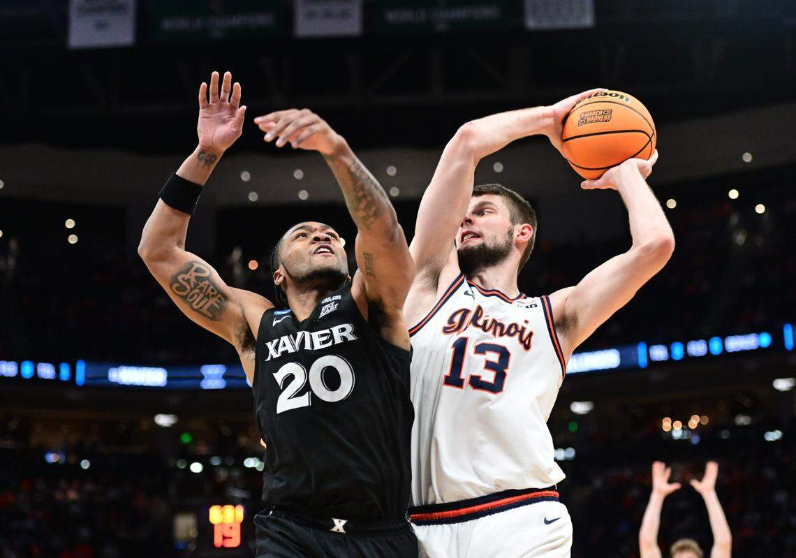Mar 21, 2025; Milwaukee, WI, USA: Illinois Fighting Illini center Tomislav Ivisic (13) drives to the hoop past Xavier Musketeers guard Dayvion McKnight (20) during the second half at Fiserv Forum. Mandatory Credit: Benny Sieu-Imagn Images