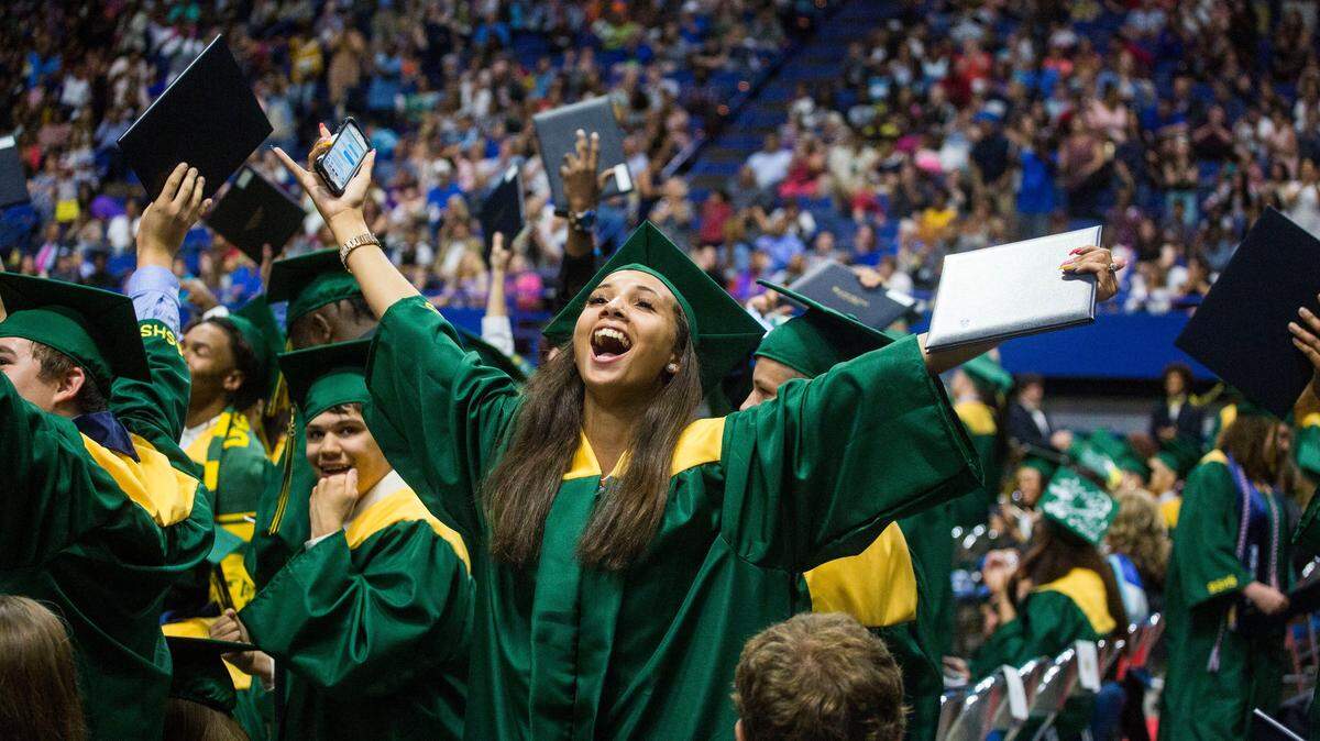 Kyrah Hardin cheers after moving her tassel during the Bryan Station High School graduation ceremony in Rupp Arena in June 2018.