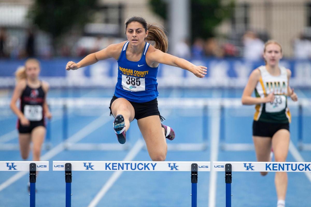 Morgan County’s Krista Perry leaps over the last hurdle on her way to victory in the 300-meter event. She also won the 100 hurdles.