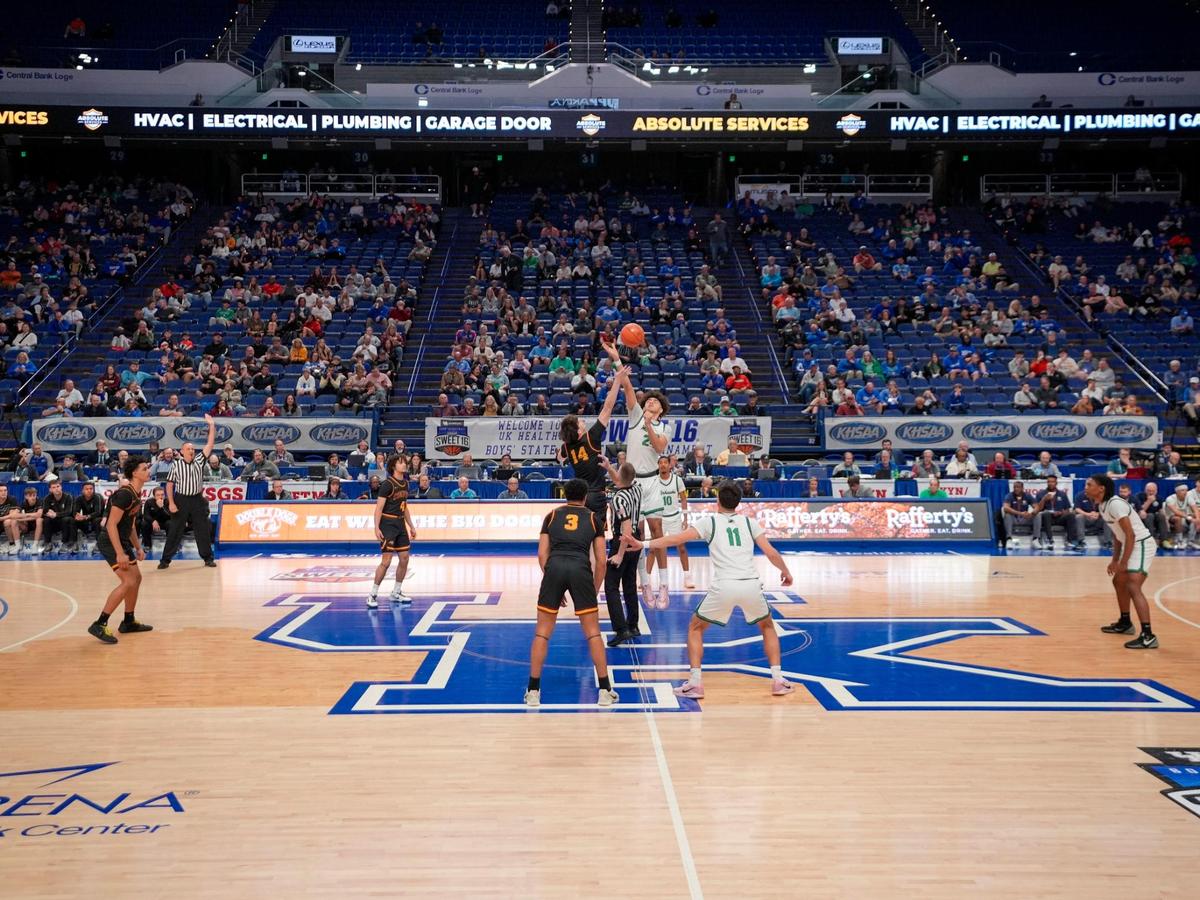 Empty seats could be seen throughout Rupp Arena’s lower level as Cooper’s Andy Johnson (14) and Great Crossing’s Malachi Moreno (24) tipped off their teams’ Sweet 16 quarterfinals matchup on Friday.