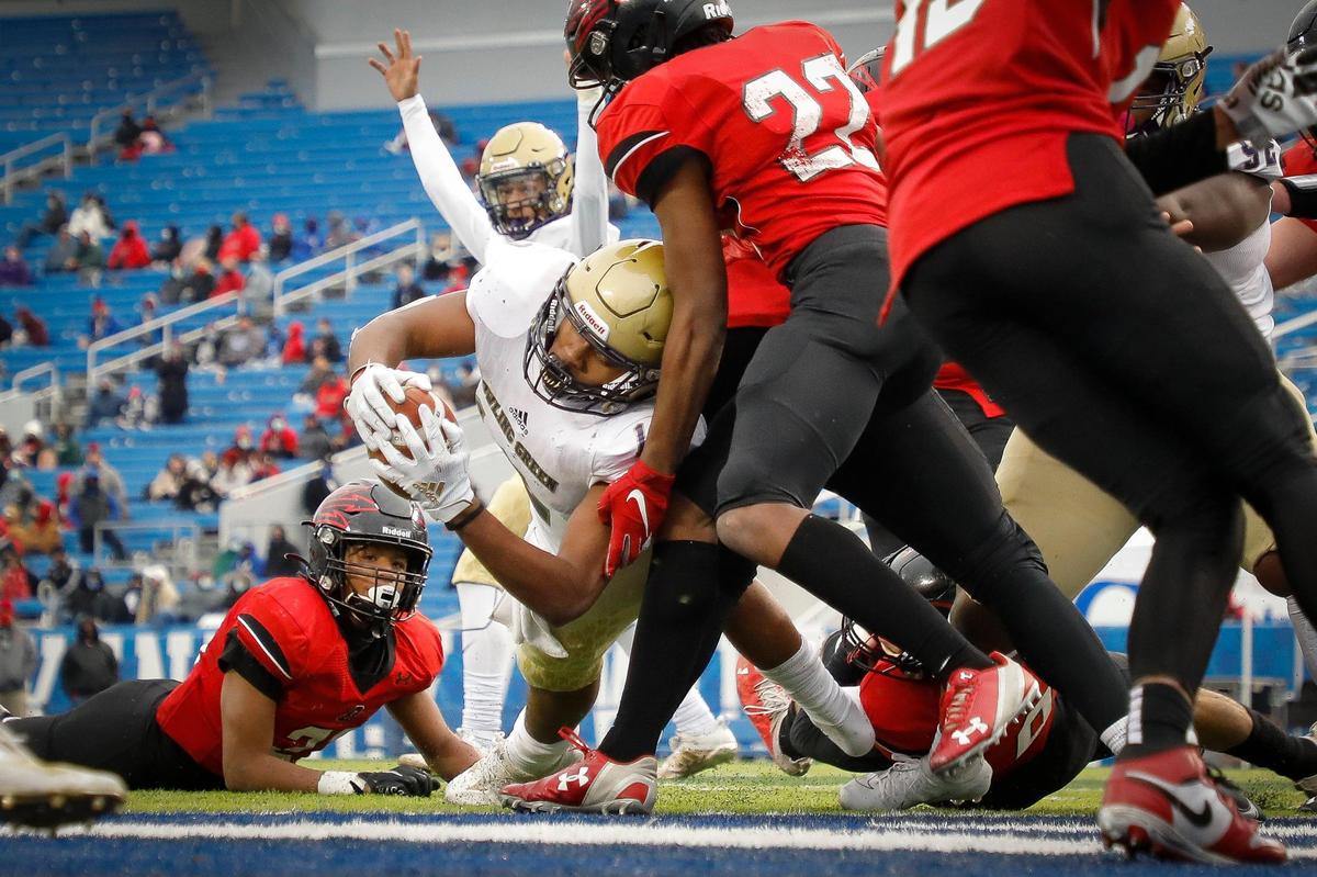 Bowling Green’s Jordan Dingle (12) scored a touchdown past Owensboro’s Javonte McHenry (22) during the Class 5A state finals at Kroger Field. Bowling Green defeated Owensboro 17-7.