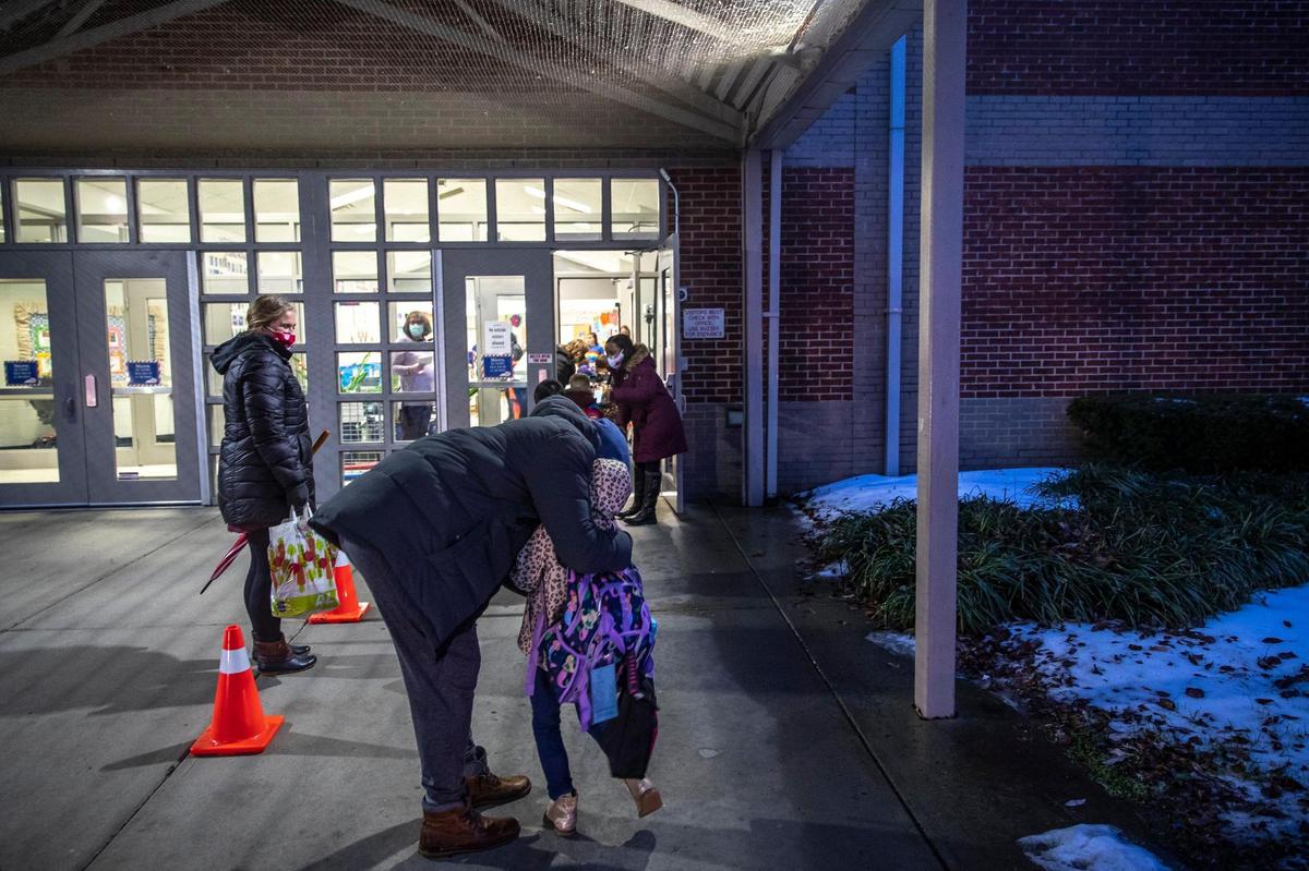Seth Eckert hugs his daughter, Annabelle, 6, as he drops her off for her first in-person day of kindergarten at Veterans Park Elementary School in Lexington, Ky., on Monday, Feb. 22, 2021. Monday was the first day of in-person classes this school year for kindergarten to second grade students at Fayette County Public Schools.