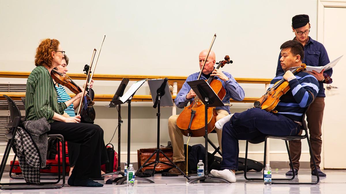 Cellist Ben Sollee and the Lexington Philharmonic string quartet prepare to rehearse with the Lexington Ballet.