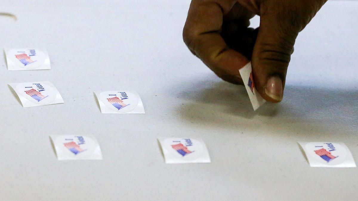 A voter picks up an “I Voted” sticker at the Ohio-Walnut precinct in the Greater Liberty Baptist Church on Chestnut Street on election day, Tuesday, Nov. 8, 2022 in Lexington, Ky.