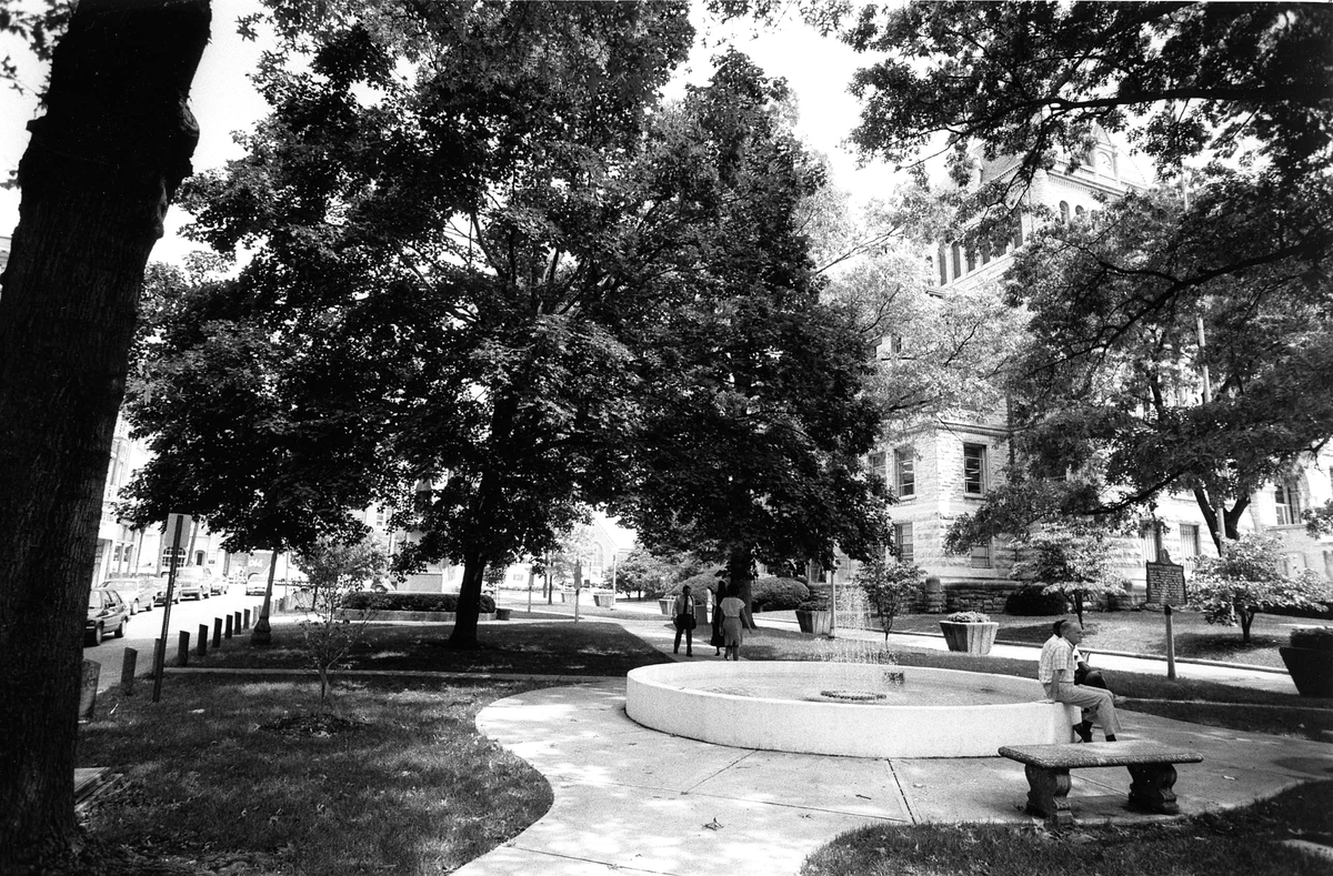 Cheapside Park on Main Street in Lexington, Aug. 24, 1989. The Fayette County Courthouse is visible through the trees, just over the fountain. The name Cheapside was taken from the historic marketplace in London, England. As a marketplace during the slavery era, Cheapside became the largest slave market in the South. After the war, it was a public square and market, hosting Court Days for public trading until 1921. The popular downtown free concert series, Thursday Night Live, started here in 1994, and in 2010, a permanent facility for the Farmers Market opened on the site with the unveiling of the Fifth Third Bank Pavilion. 