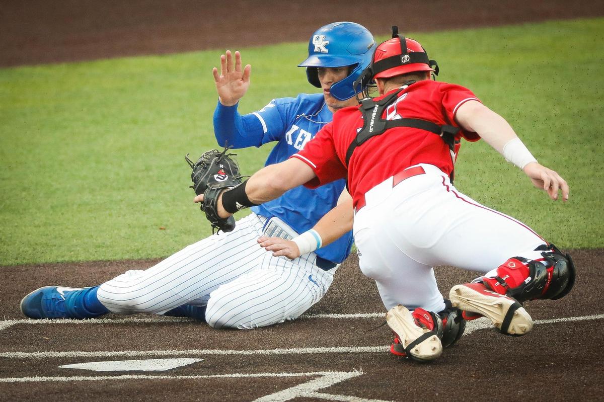 Kentucky’s John Rhodes slides past Louisville catcher Henry Davis to score a run during the fourth inning Tuesday night.