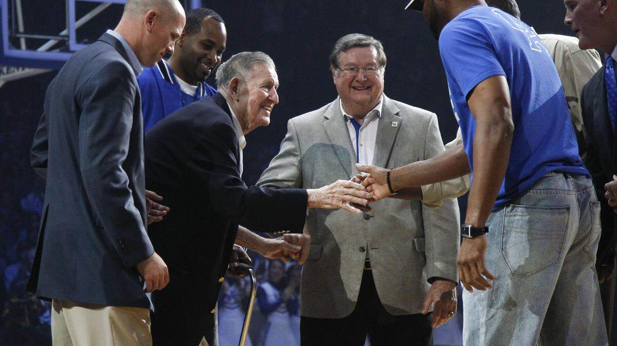 Wallace "Wah Wah" Jones (with cane) was greeted by other past Kentucky basketball champions including (from left) Jeff Sheppard, Derek Anderson, Joe B. Hall, Ron Mercer (shaking Jones' hand), Jack Givens (obscured) and Kyle Macy during Big Blue Madness on Oct. 12, 2012.      