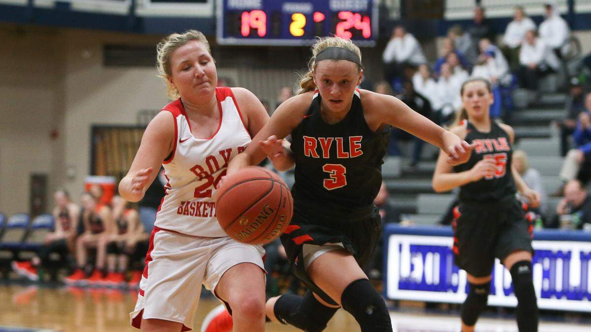 Ryle’s Brie Crittendon battled for the loose ball against Boyd County’s Emma Borders, left, in the semifinals of the Traditional Bank Holiday Classic on Dec. 22, 2018.