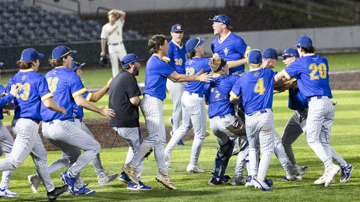 Henry Clay’s players and coaches, including a leaping Blake Miniard just right of center, celebrated the Blue Devils’ 2-0 win over Sayre at the conclusion of the 42nd District Tournament championship game at Legends Field on Wednesday.