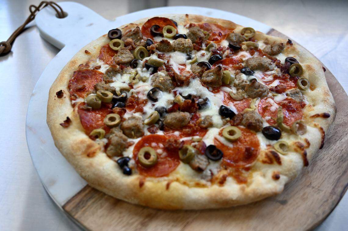 Frenchy’s Pizza Food Truck Olive the Glory is topped with pepperoni, sausage, bacon, green olives and black olives.