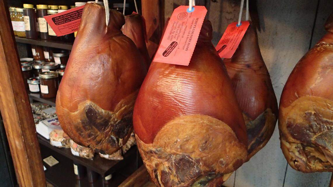 Cured country hams at Scott Hams in Greenville. A new book explores how something once viewed as the food of common folk is being re-envisioned as a delicacy.