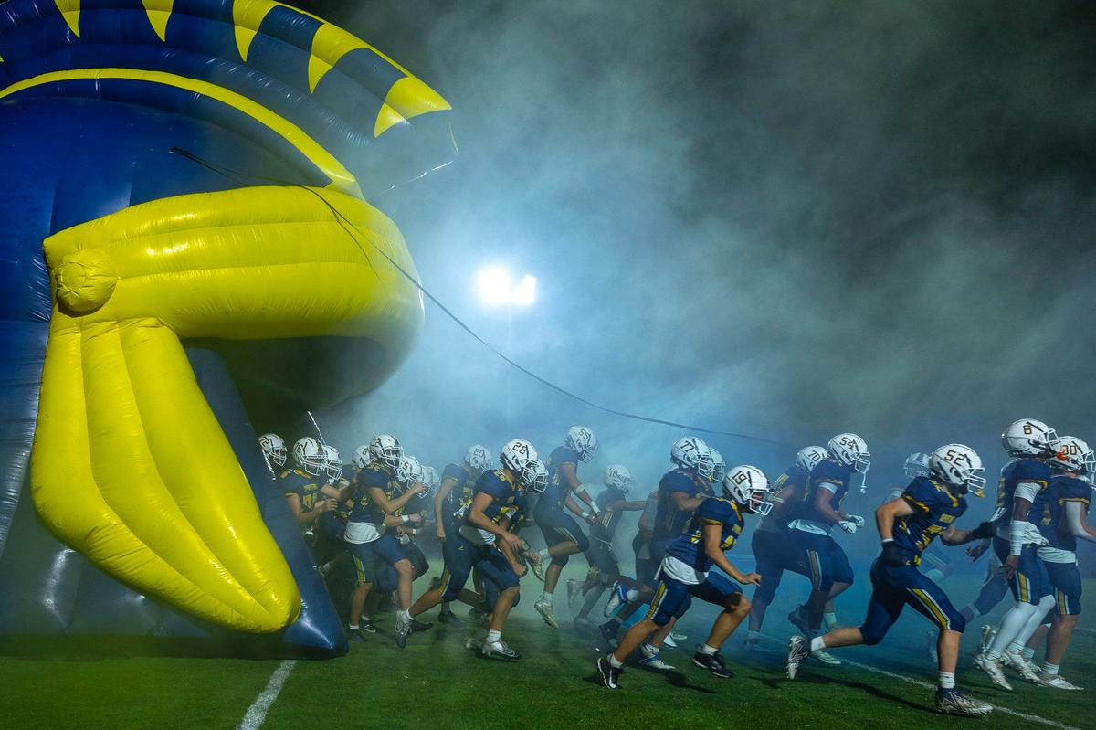Sayre’s football players take the field before a home game against Ludlow on Sept. 6.