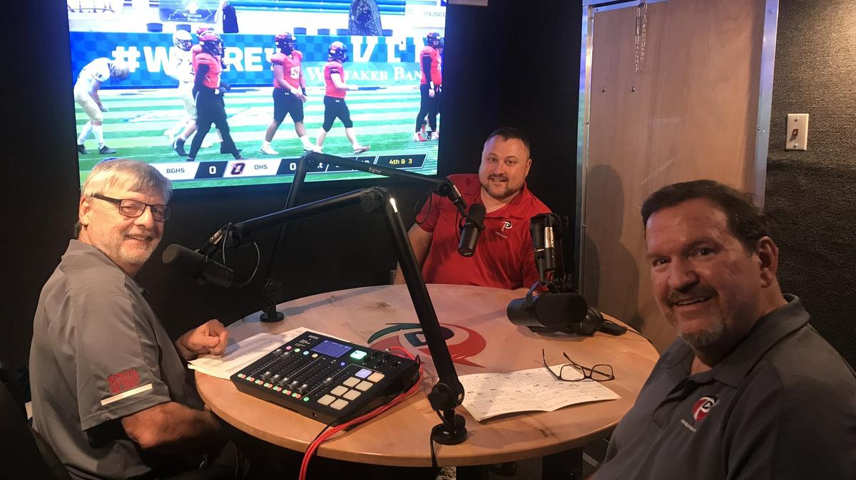 Former football coach Mike Meighan, left, PrepSpin.com founder William Warfield and play-by-play man Gary Ball sit inside the company’s mobile studio as they prepared for the 2021 high school football season. Ball suffered a stroke last year but has been recovering well and now can broadcast games from inside the PrepSpin.com studio.