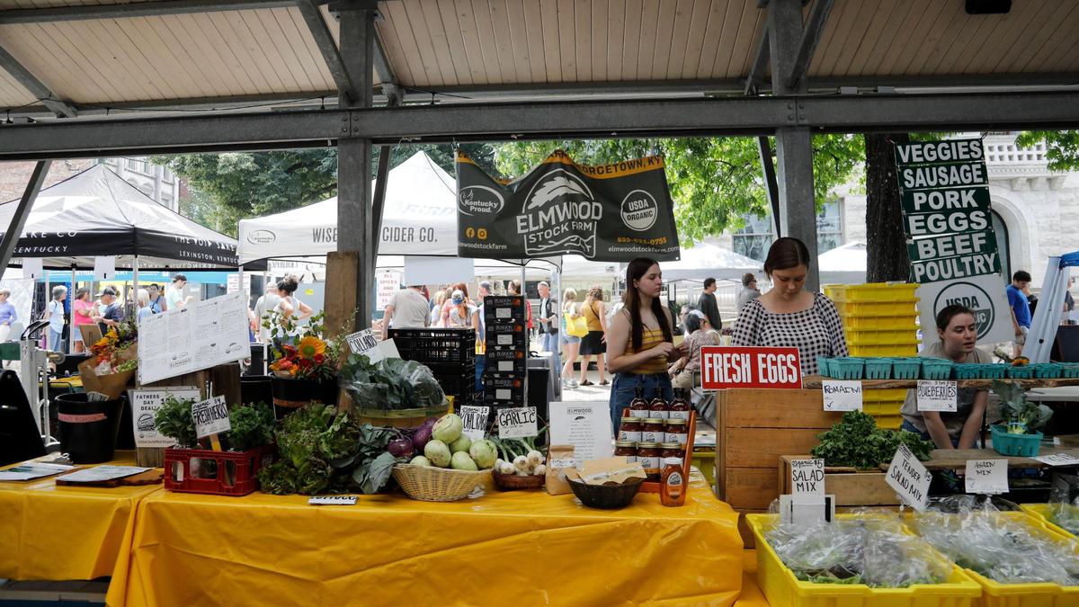 From left, Pearl Altman, Kirstin Pierce and Adeleine Johnson sell for Elmwood Stock Farm’s booth on Saturday, June 17, 2023 at the Fifth Third Pavilion in downtown Lexington, Ky.