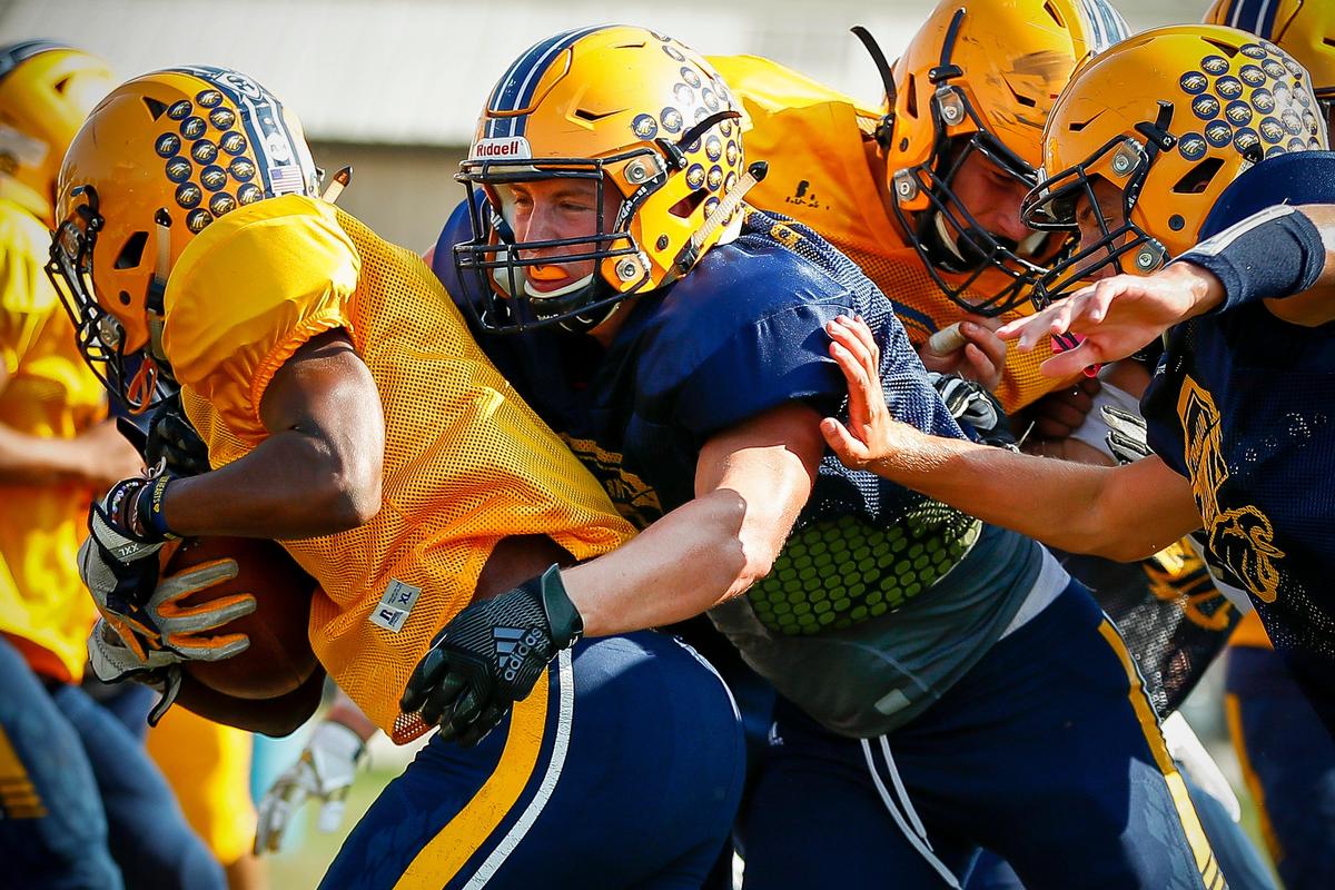 Franklin County’s Brady Holleran, center, tackled Issaia Israel during practice Tuesday..