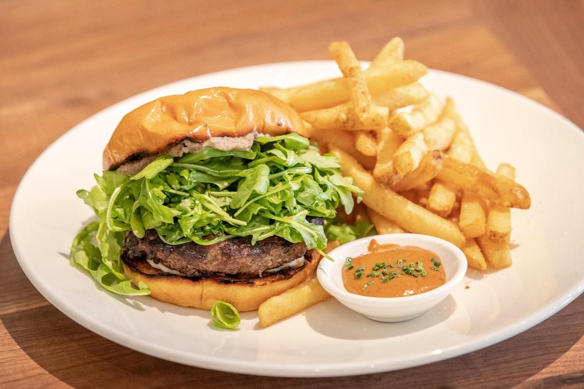 The cafe burger, with truffled arugula, is an 8 ounce brisket and short rib blend at Bella Cafe & Grille.