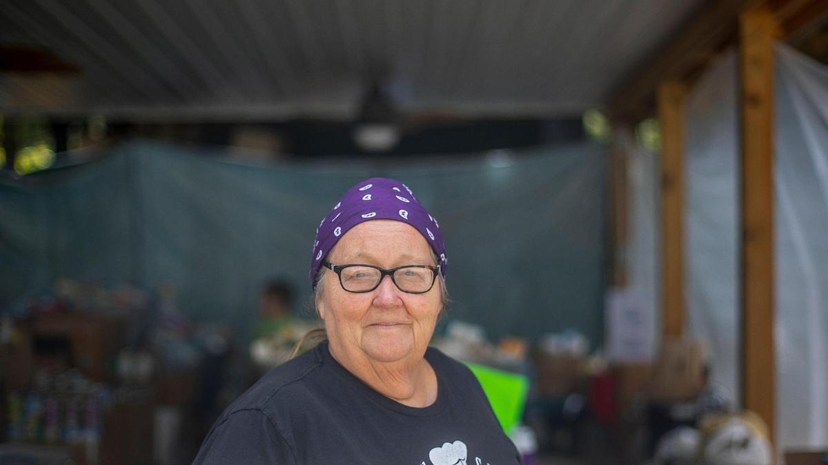 Gwen Johnson, Hemphill Community Center board chair, poses for a portrait in an open shelter filled with donated items for flooding victims outside the community center in Hemphill, Ky., on Wednesday, Aug. 31, 2022. Johnson was born and raised in Hemphill, a former coal camp up the hollow from Fleming-Neon in Letcher County.