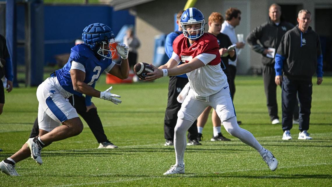 Kentucky quarterback Zach Calzada hands the ball off to running back Dante Dowdell during Wednesday’s practice at the Joe Craft Football Training Facility.