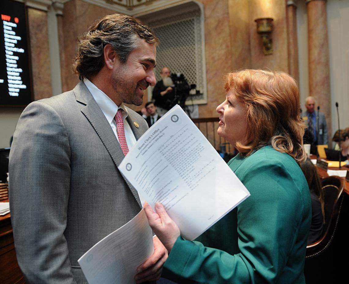 FRANKFORT, January 7 -- House Majority Whip Chad McCoy, R-Bardstown (left), speaks with House Minority Floor Leader Joni Jenkins, D-Shively, on the first day of session in the House.