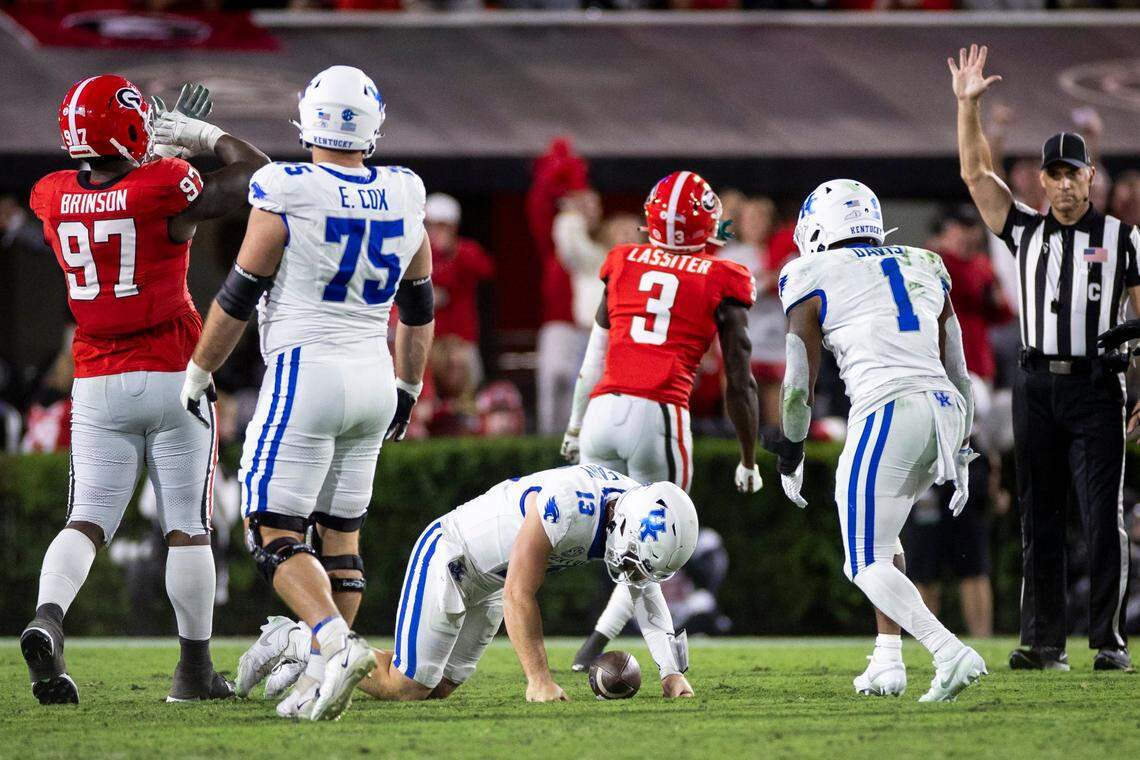 Kentucky quarterback Devin Leary (13) gets up after being sacked by the Georgia defense during the game at Sanford Stadium in Athens, Ga, on Saturday.