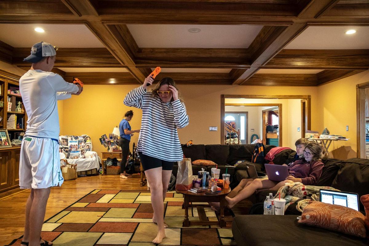 Macy Dungan, 17, and her boyfriend, Nate O’Bryan, 18, watch their friends Sam Yocum, 17, from left, Rhealee Ellis, 15, and Tatum Williams, 17, battle with Nerf darts during a break between their virtual classes at Macy’s grandmother’s house in Frankfort, Ky., Tuesday, Sept. 15, 2020.